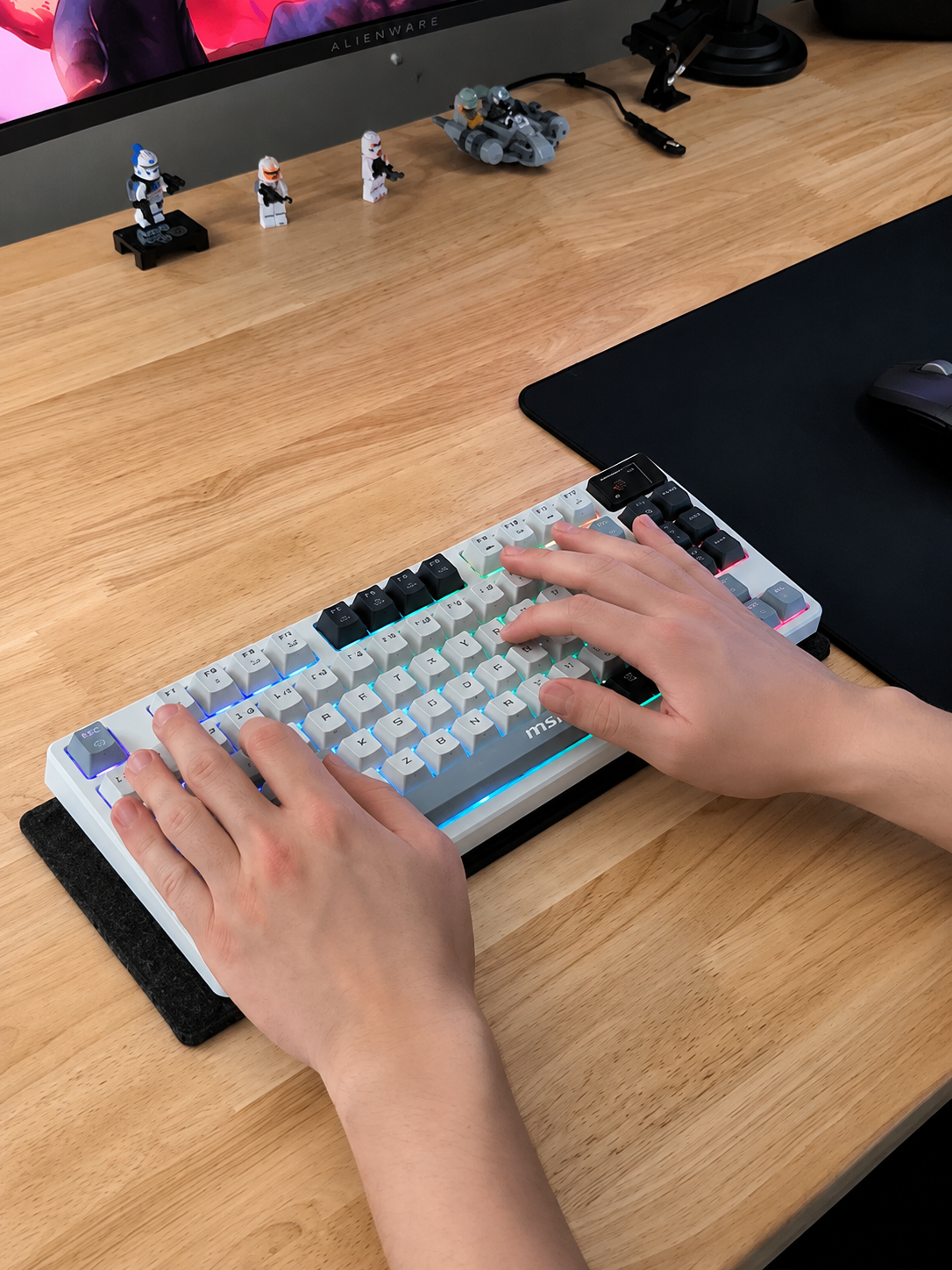 Dark green desk setup with RGB mechanical keyboard