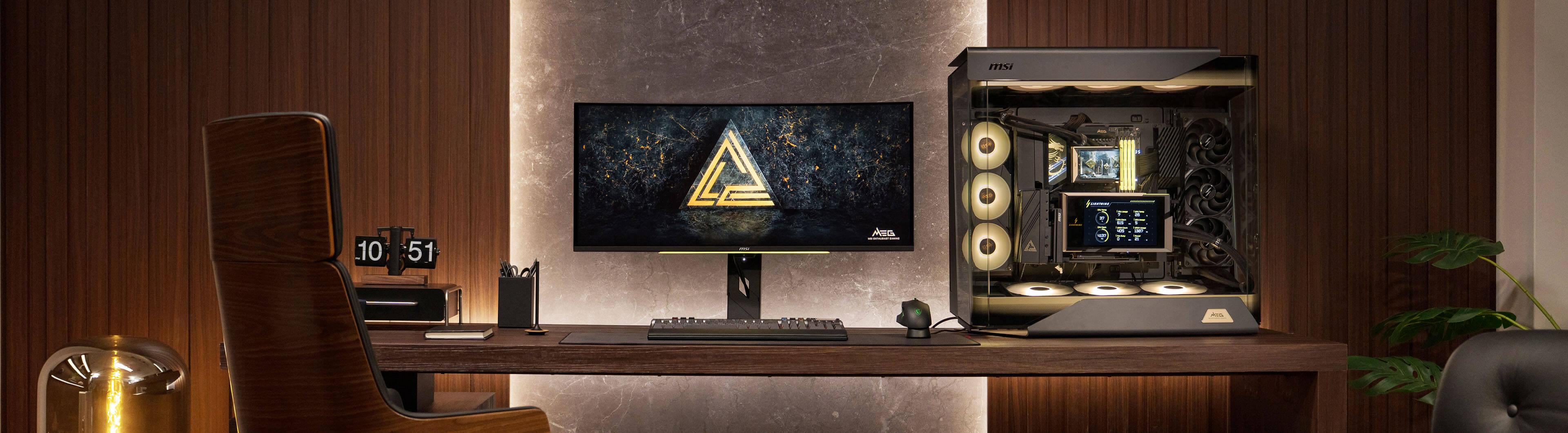 MEG flagship home studio desk setup with monitor, PC case, and audio gear