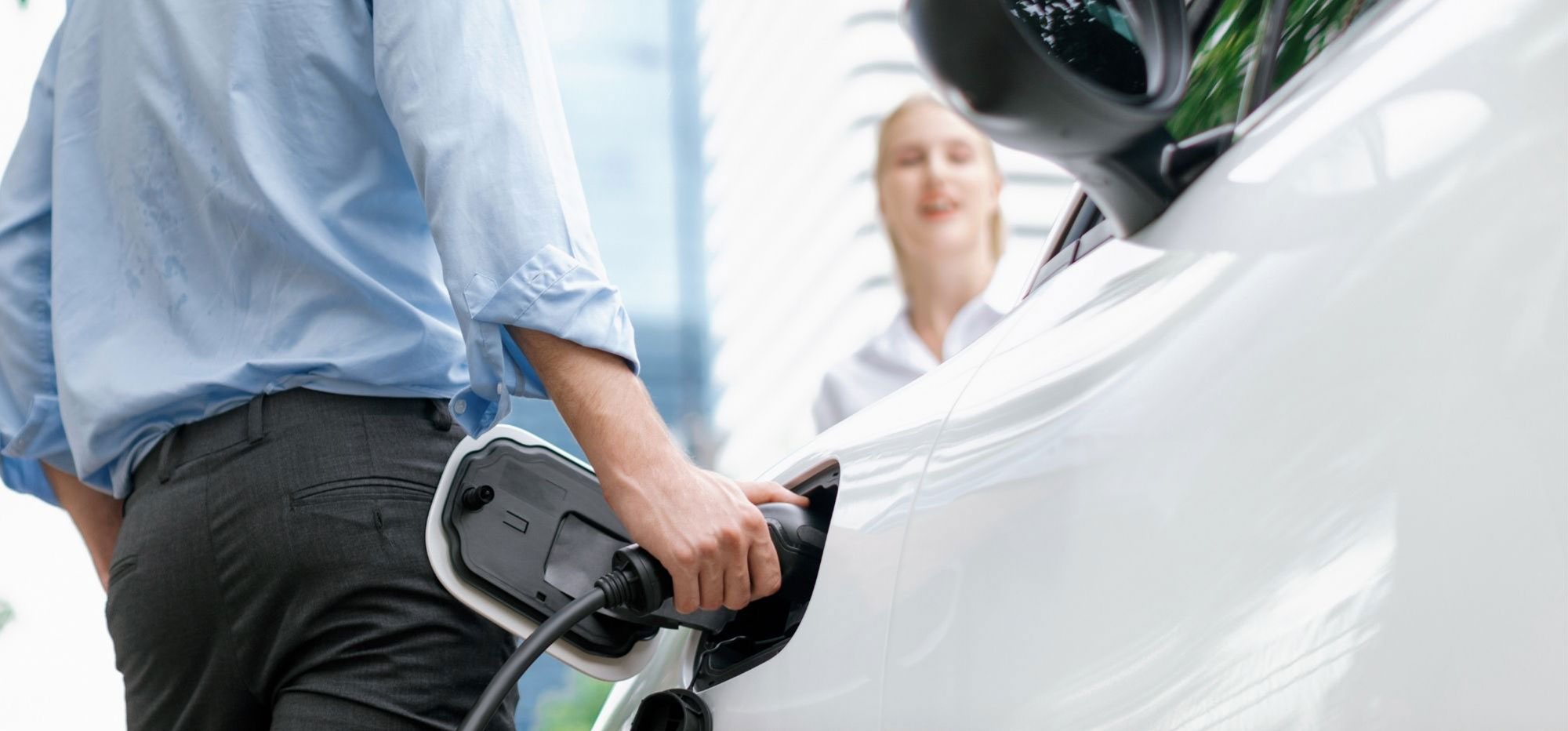 Hotel guest plugging in an EV using Plug & Charge, QR, or RFID.