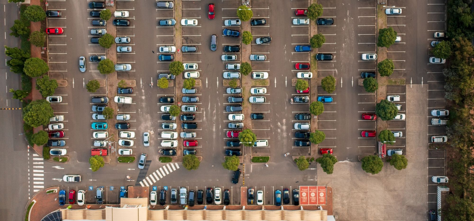 A vehicle in a busy retail car park getting ready to charge at an MSI charging station.