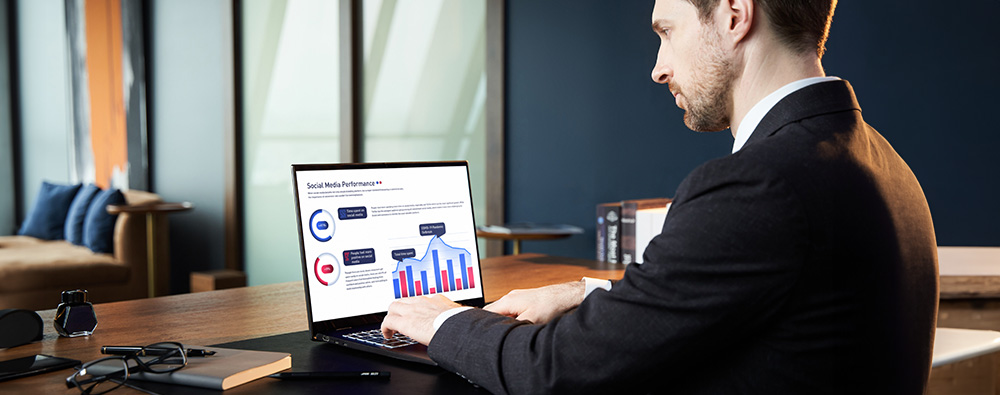 A high-level executive working on a business laptop in a corporate office, illustrating the enterprise sector.