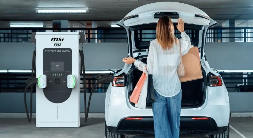 A woman and her electric vehicle that's all charged and ready to go after shopping